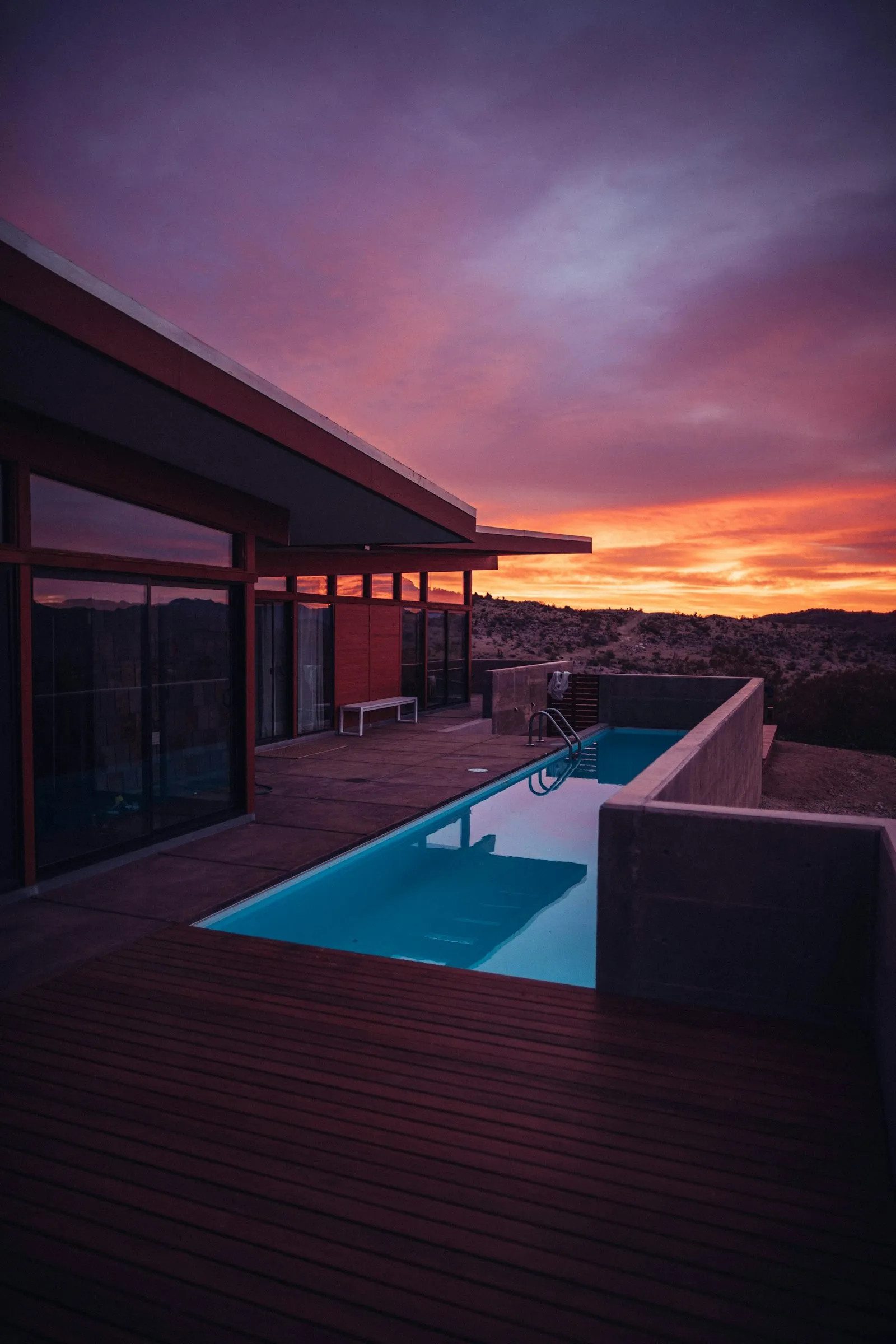 A modern villa with a pool at dusk